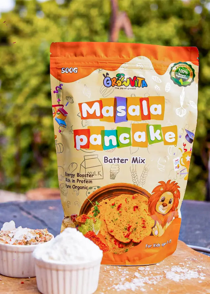 Packaging of Gokulam Masala Pancake Batter Mix with colorful design on a blurred outdoor background.